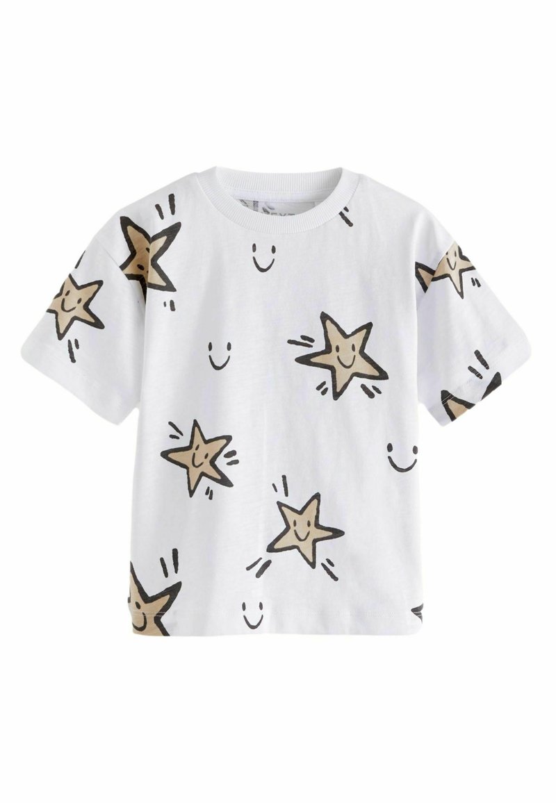 Camiseta de manga corta blanca con contornos negros de estrellas sonrientes en color beige, decorada con caritas sonrientes dispersas, fabricada en suave material de algodón.