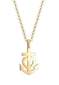 Goldkette mit einem Anhänger in Form eines Ankers, der ein Herzdesign aufweist, befestigt an einer Gliederkette. Glatte Textur, polierte Oberfläche.