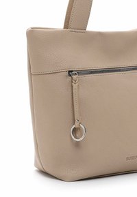 Borsa tote in pelle beige con design strutturato, base piatta, tasca con zip frontale e dettagli in metallo argento. Superficie testurizzata e dettagli cuciti.