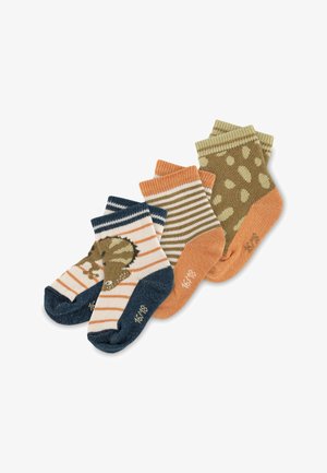 Three pairs of kids' socks: one striped with a dinosaur motif, one striped in brown and orange, one with green polka dots on an orange base.