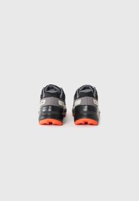 Black and gray sneakers with a textured finish, orange rubber outsole, and padded collar for comfort. Notable reflective accents on the sides.