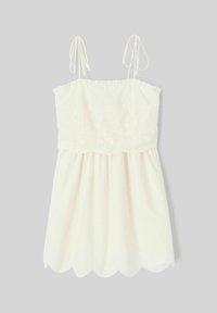 Robe crème claire avec bretelles spaghetti réglables, motif floral brodé au niveau du corsage, et ourlet festonné. Tissu doux et fluide.