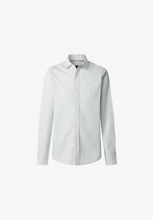 Chemise blanche à manches longues avec de petits pois noirs, col classique, devant à boutons, et ourlet droit. Texture lisse, coupe ajustée.