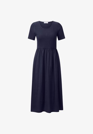 Tengerészkék tunika ruha rövid ujjakkal, kerek nyakkivágással és laza derekkal, fodros szoknyával, amely a földre ér.