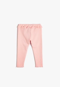 Vaaleanpunaiset legginsit, joissa on ribbetty tekstuuri. Housuissa on rypytetty vyötärö ja aallotettu helma nilkoissa. Hoikkamuotoinen malli, ei näkyviä kuvioita.