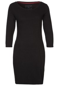 Musta istuva mekko, jossa pitkät hihat, ribbineulos ja pyöreä pääntie. Kauluksessa näkyy viininpunainen vuori.