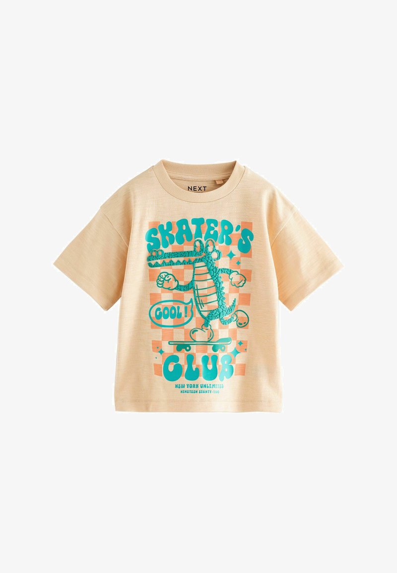 Beiges T-Shirt mit kurzen Ärmeln, blauem Cartoon-Krokodil auf einem Skateboard und Text "Skater's Club" und "Cool!" in blauer Schrift.