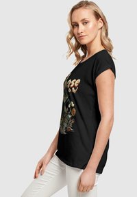 ABSOLUTE CULT TOM AND JERRY-THE CHASE IS ON  - T-shirts med print - black
