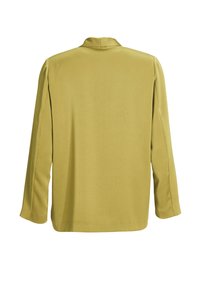 Blazer jaune moutarde à manches longues vu de dos, avec un col simple et un ourlet droit sur fond blanc.