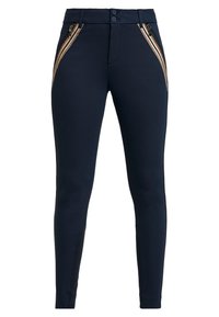 Marina leggings med en mjuk textur, dubbla dragkedjefickor med detaljerad sömnad och en åtsittande silhuett. Tvåknappsstängning i midjan.