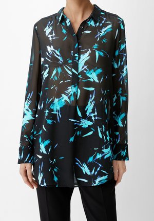 Chemisier noir en voile avec un motif floral abstrait bleu, devant à boutons, manches longues et col. Coupe ample et ourlet arrondi.