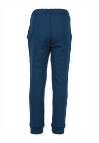 Donkerblauwe sweatpants gemaakt van zacht materiaal, met een elastische tailleband, zijzakken en aansluitende boorden bij de enkels.