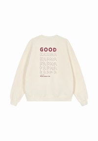 Felpa crema con una stampa grafica in bordò, che mostra il testo "GOOD" e la ripetizione di "KARMA" in vari caratteri sul retro.