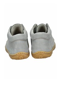 Zapatos de cuero texturizado gris con forma redondeada, suela en contraste en color marrón claro y forro interior blanco. Se pueden ver pequeños acentos de costura naranja.