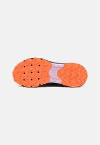 Black athletic shoe sole featuring aggressive rubber treads in orange and purple with a textured surface for improved traction and durability.