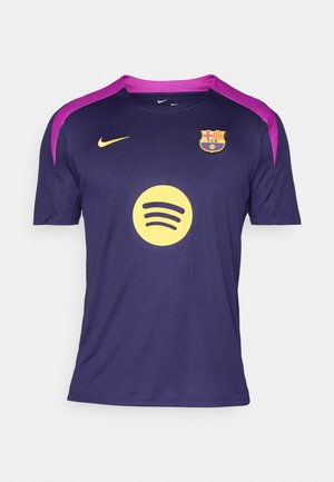 Temno vijolična nogometna majica FC Barcelone z rumenim logotipom Nike, rumenim logotipom sponzorja Spotify in vijoličnimi trakovi na ramah.