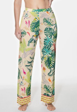 Lightweight, beige pajama pants with a tropical print featuring green leaves, colorful birds, and accents of patterned trim at the hem.