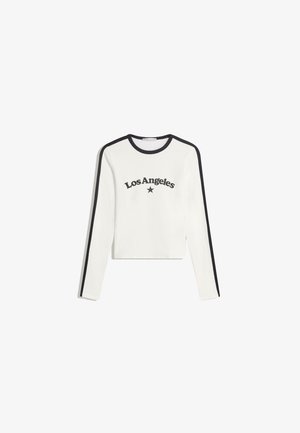 Hvid langærmet top med sort kant, prydet med teksten "Los Angeles" og et stjernedesign trykt på forsiden. Designet er cropped og lavet af bomuldsmateriale.