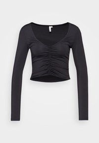 Svart långärmad topp med djup V-ringning och samlad detalj i mitten. Slim fit med en kortad nederkant, tillverkad av smidig, stretchig tyg.