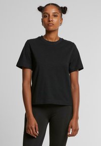 Zwarte katoenen t-shirt met korte mouwen, ronde hals en een relaxte pasvorm. Soepele textuur, geen zichtbare patronen of accenten.