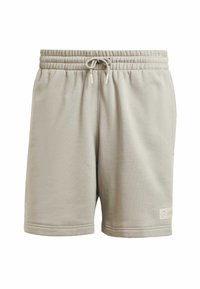 Beige svedshorts med elastisk talje og snor, med sidelommer og et lille logo-patch. Blødt, struktureret stof.