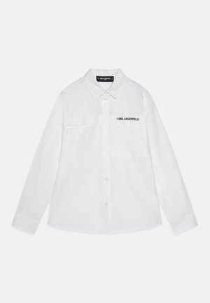 White button-up shirt made of smooth fabric, featuring a chest pocket and subtle black "KARL LAGERFELD" logo on the front.