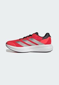 Red athletic shoe with a breathable mesh upper, silver stripes, black accents, and a cushioned white sole for support and comfort.