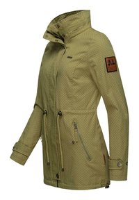 Green waterproof jacket with white polka dots, zippered pockets, drawstring waist, and a brown leather tag on the left sleeve.