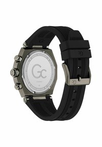 Czarny zegarek na silikonowym pasku z heksagonalną kopertą ze stali nierdzewnej, posiadający przezroczysty tył i boczne przyciski. Oznaczenia wskazują na szwajcarski mechanizm.