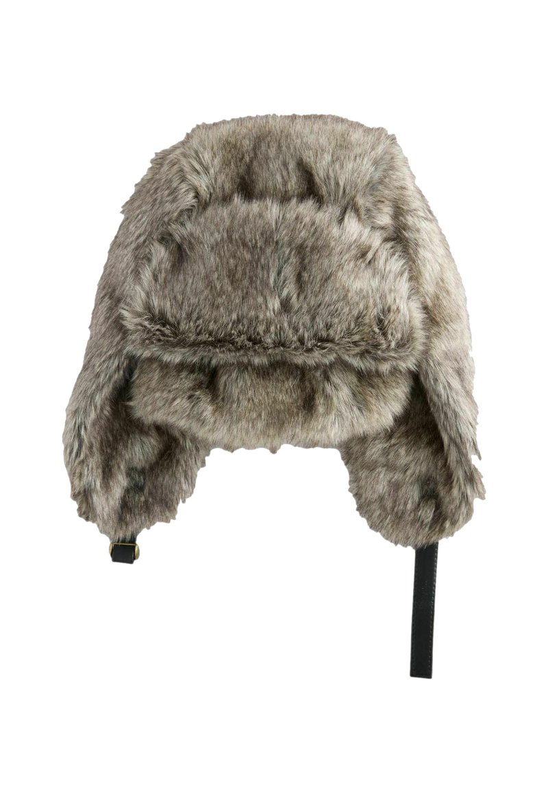Faux fur ushanka hat in gray with rounded crown, ear flaps, and black chin strap; soft texture with subtle variations in color.