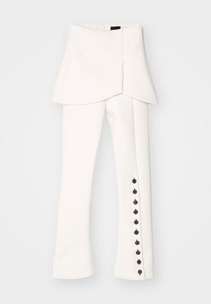 White tailored trousers with a peplum waist, side zip closure, and black button accents along the outer leg seam. Smooth, structured fabric.