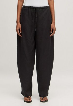 Zwarte linnen wijde broek met een elastische tailleband en trekkoord. Soepele textuur, lichtgewicht stof en een losse pasvorm voor comfort.