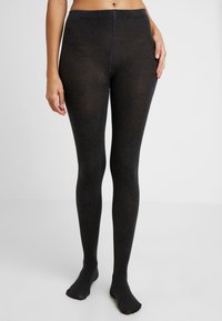 Czarne, dziane rajstopy wykonane z miękkiego, elastycznego materiału. Posiadają szeroką talię i dobrze dopasowaną sylwetkę, z gładką fakturą na całej powierzchni.