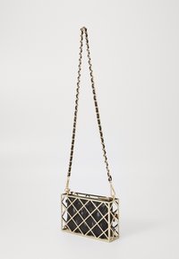 Black leather handbag with gold metal frame and chain strap. Features a diamond pattern and zip closure. Compact rectangular shape.