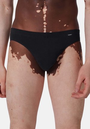 Schwarze Baumwollslips mit glatter Textur und einem niederen Schnitt. Verfügt über einen schlichten Bund mit dem "SKINY"-Markenlogo an der Seite.