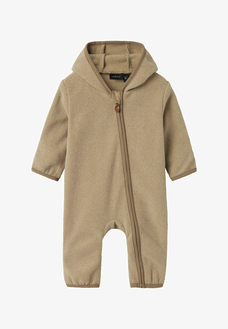 Světle béžový huňatý dětský overal s kapucí, předním zipem, elastickými manžetami a dlouhými rukávy, vyrobený z měkkého fleecového materiálu.