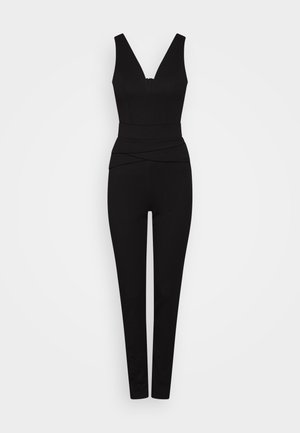 Zwarte jumpsuit met een V-vormige halslijn, aansluitende lijfje en taps toelopende pijpen. Kenmerkt zich door gelaagde stofaccenten bij de taille voor extra textuur.