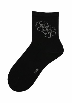 Schwarze Knöchelsocke mit zwei weiß umrandeten Blumen nahe dem Bündchen und kleinem weißem Textlogo im Bereich des Fußgewölbes.