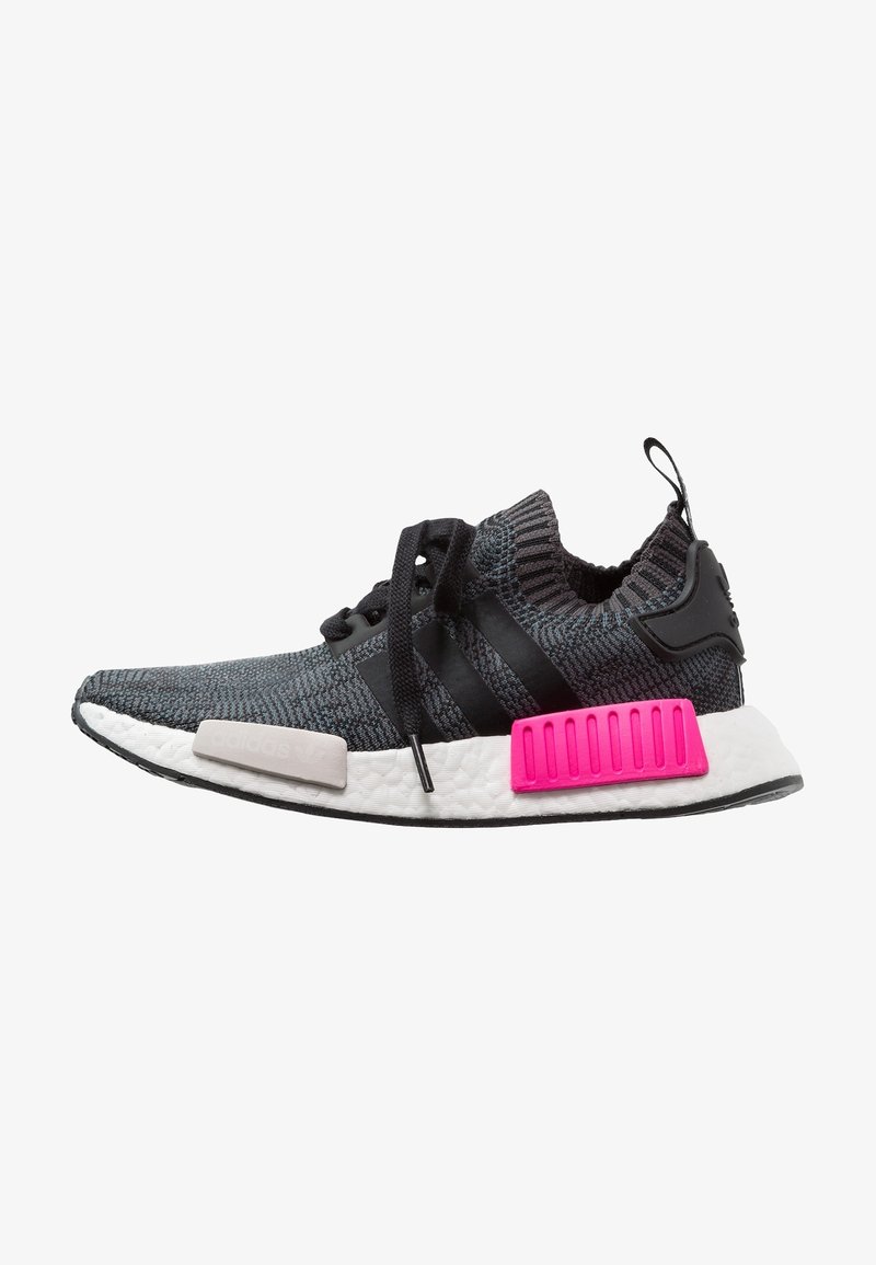 Gray knitted sneaker with black accents, white midsole, and vibrant pink heel piece. Features black laces and three striped logo detail.