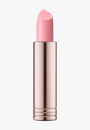 Pink lipstick in a metallic rose gold cylindrical case. The bullet has a rounded tip with a logo embossed on the top.