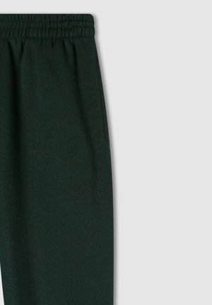 Pantaloni della tuta verde scuro con cintura elastica, texture morbida e dettagli con tasche laterali. Progettati per comfort e abbigliamento casual.