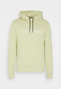 Ljusgrön huvtröja i mjukt material med en framtill liggande ficka, justerbar dragsko i huvan och en stor vit "Calvin Klein"-logotyp.