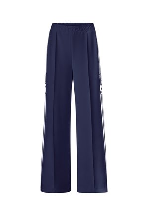 Pantalons larges bleu marine avec une taille élastique, présentant des rayures latérales blanches et une texture de tissu lisse et léger.
