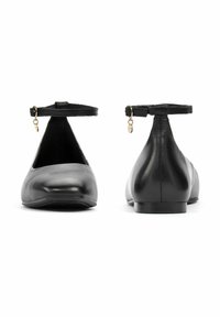 Czarne skórzane baletki z paskiem wokół kostki, płaską podeszwą, gładką fakturą i złotymi akcentami na pasku.