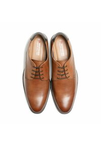 Bruine leren nette schoenen met een gladde afwerking, ronde neus, vetersluiting en contrasterende zwarte accenten op de hak. Maat 42.