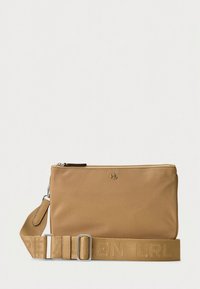 Tan leather crossbody bag with a zip closure, adjustable strap, and embossed logo. Smooth texture and minimal design features.