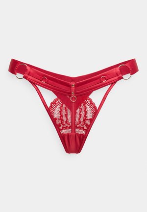 Red lingerie featuring satin fabric, intricate lace detailing, a sheer back, and adjustable straps with metallic accents and buttons.