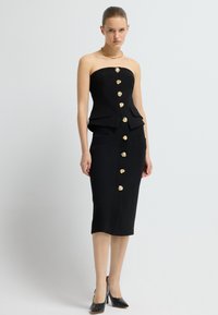 Schwarzes trägerloses Kleid mit einem taillierten Oberteil, Peplum-Taille und goldenen Dekorationsknöpfen. A-Linien-Silhouette mit zwei Fronttaschen und knielangem Saum.