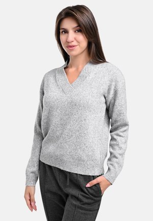 Light gray, knitted v-neck sweater with long sleeves and ribbed hem; paired with dark gray, loose-fitting pants. Soft texture.