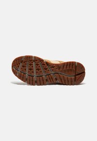 Sole in gomma marrone con superficie testurizzata, dotata di un motivo a battistrada geometrico per la presa e dettagli del logo sul lato.
